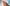 coral semi-cured gel nails on hands on top of a blue and white stripped beach towel at the beach
