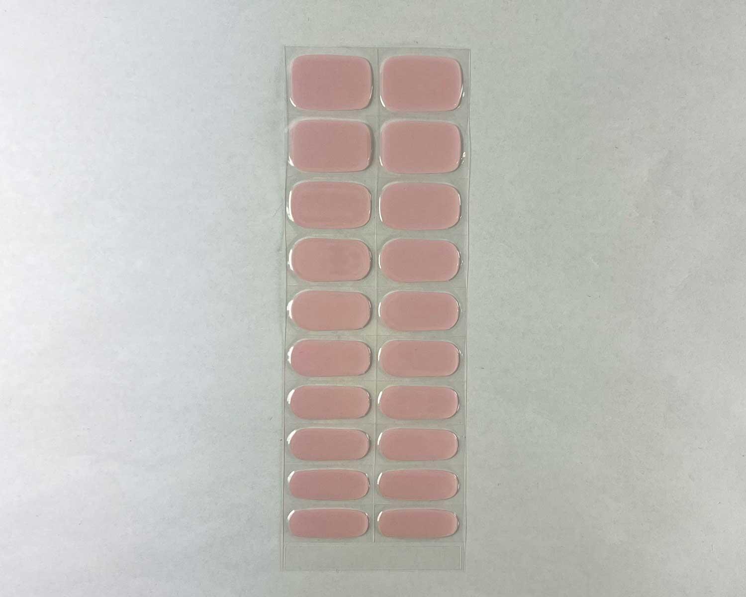 Pale pink power semi-cured gel nails strip showing 20 pieces with 10 different sizes on white background
