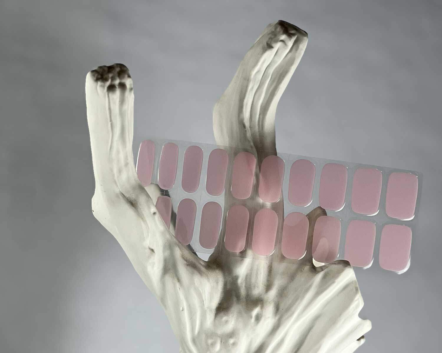 Pale pink power semi-cured gel nails in mockup to show product against white textured tree