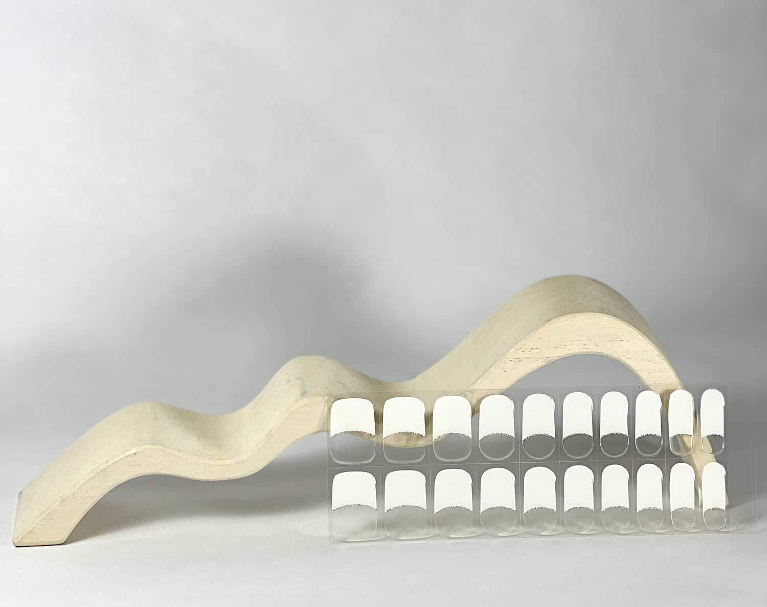 French white silver semi-cured gel nails in mockup to show product against white wave wooden block