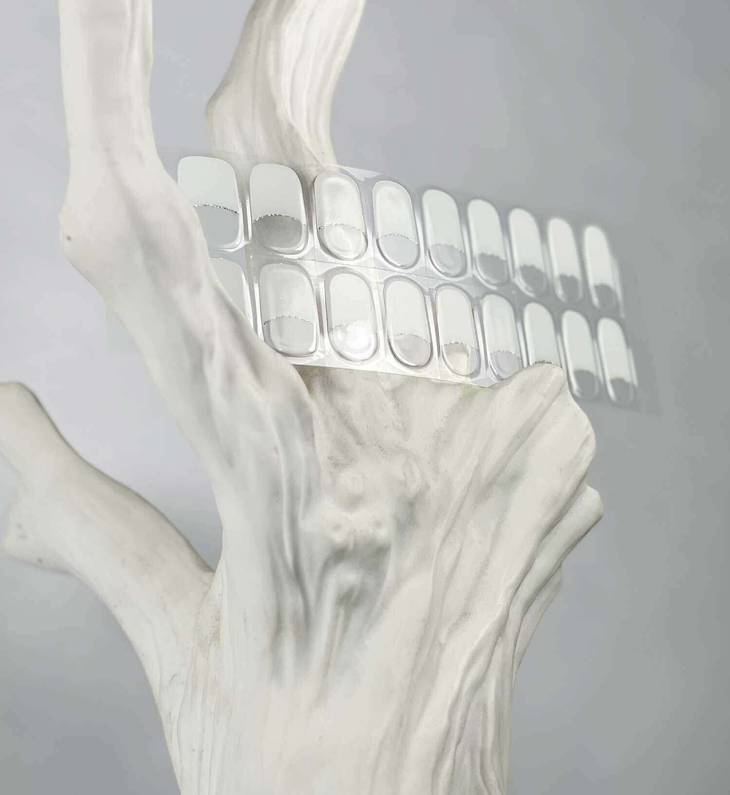 French white silver semi-cured gel nails in mockup to show product against white tree