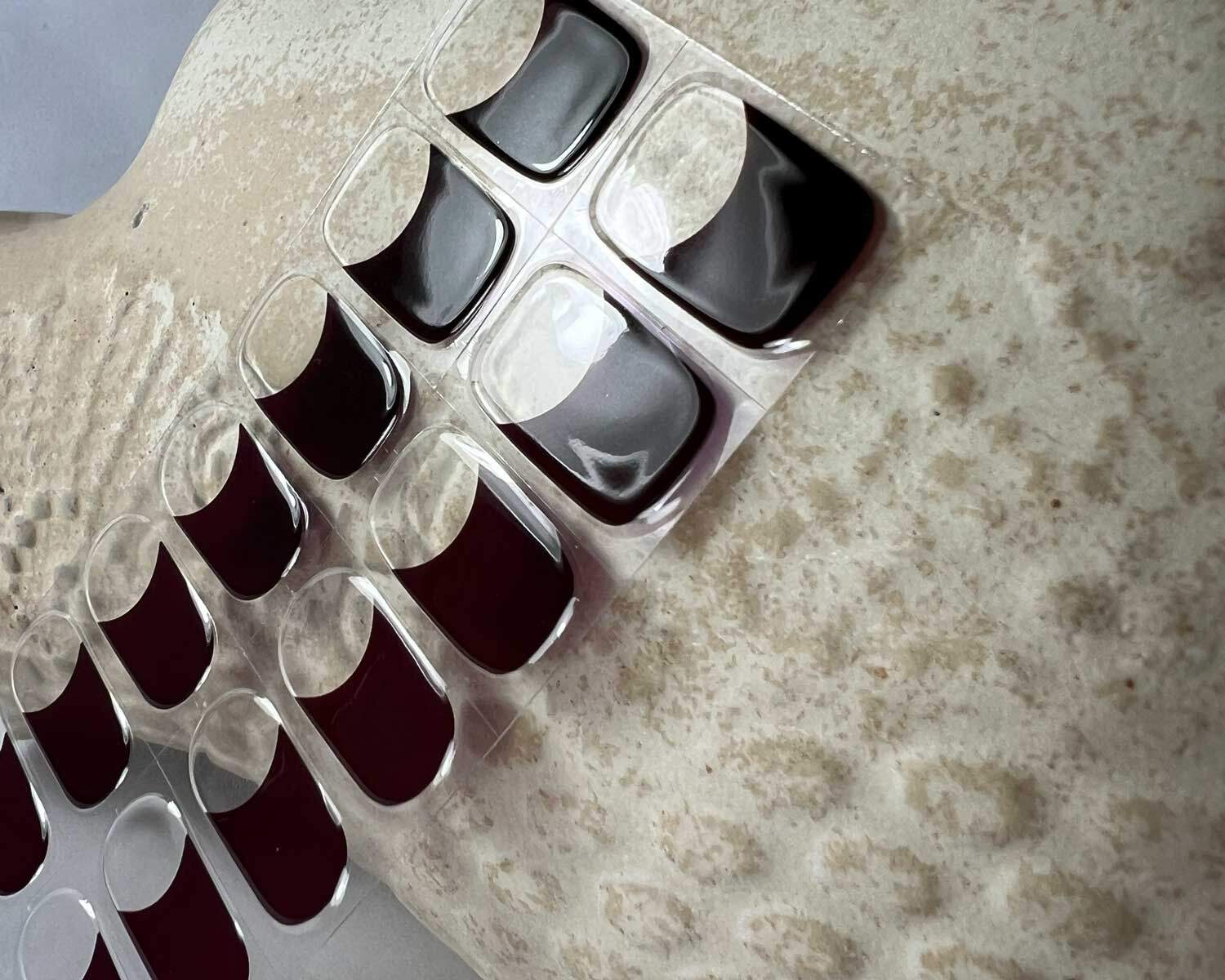 French wine red semi-cured gel nails in mockup to show product against textured ceramic head zoomed in