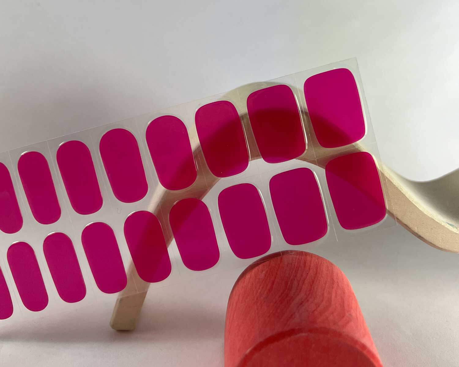 Lipstick love pink semi-cured gel nails in mockup zoomed in to show product against red and white wave wooden blocks