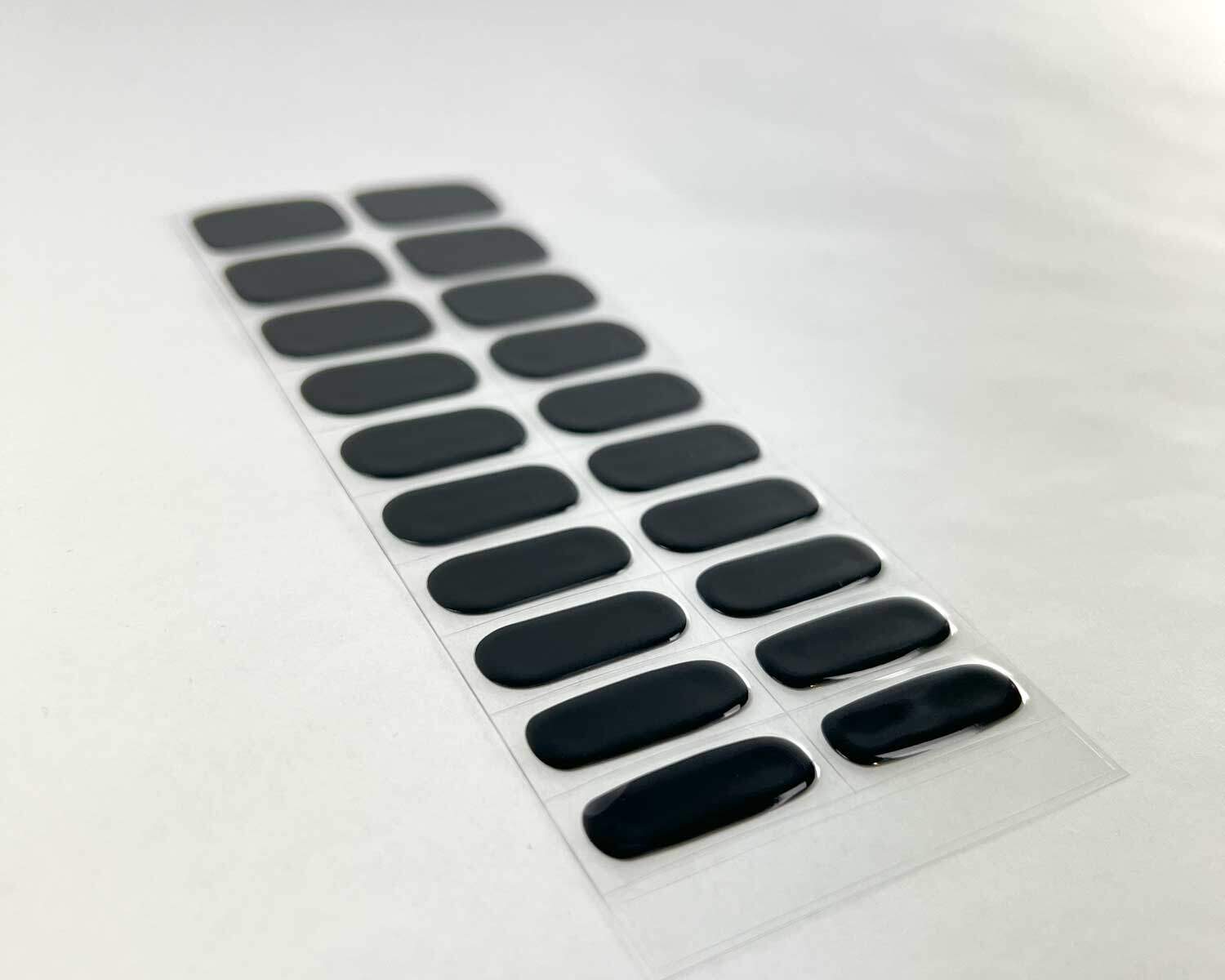 Night black semi-cured gel nails on angle zoomed in on white background