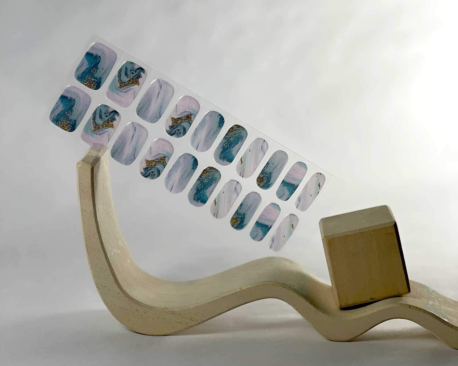 Opal Glitter Gold semi-cured gel nails in mockup to show product against white wooden blocks