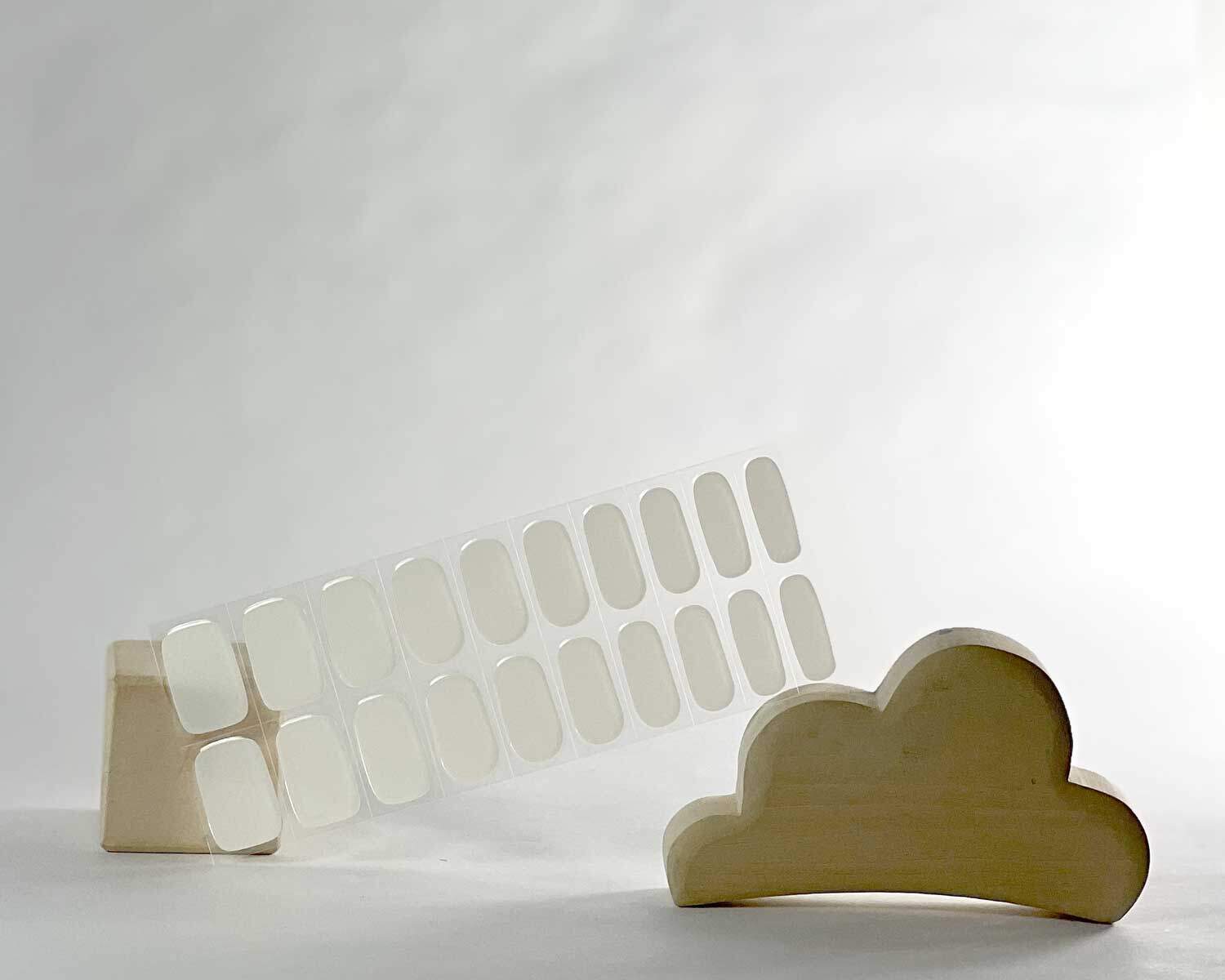 Pure White semi-cured gel nails in mockup to show product against white wooden blocks