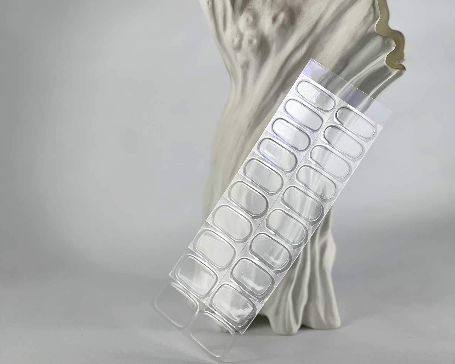 transparent-semi-cured-nails-strip-blue-tree Transparent clear semi-cured gel nails in mockup to show product against white textured tree