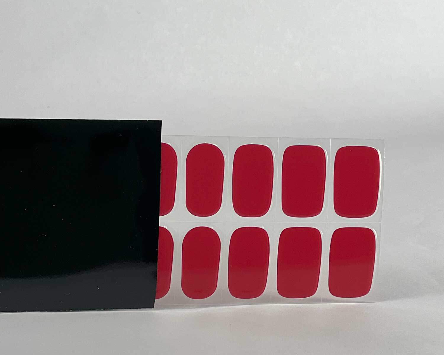 Vixen red semi-cured gel nails in black light sensitive strip with la-bek uv lamp box in the background