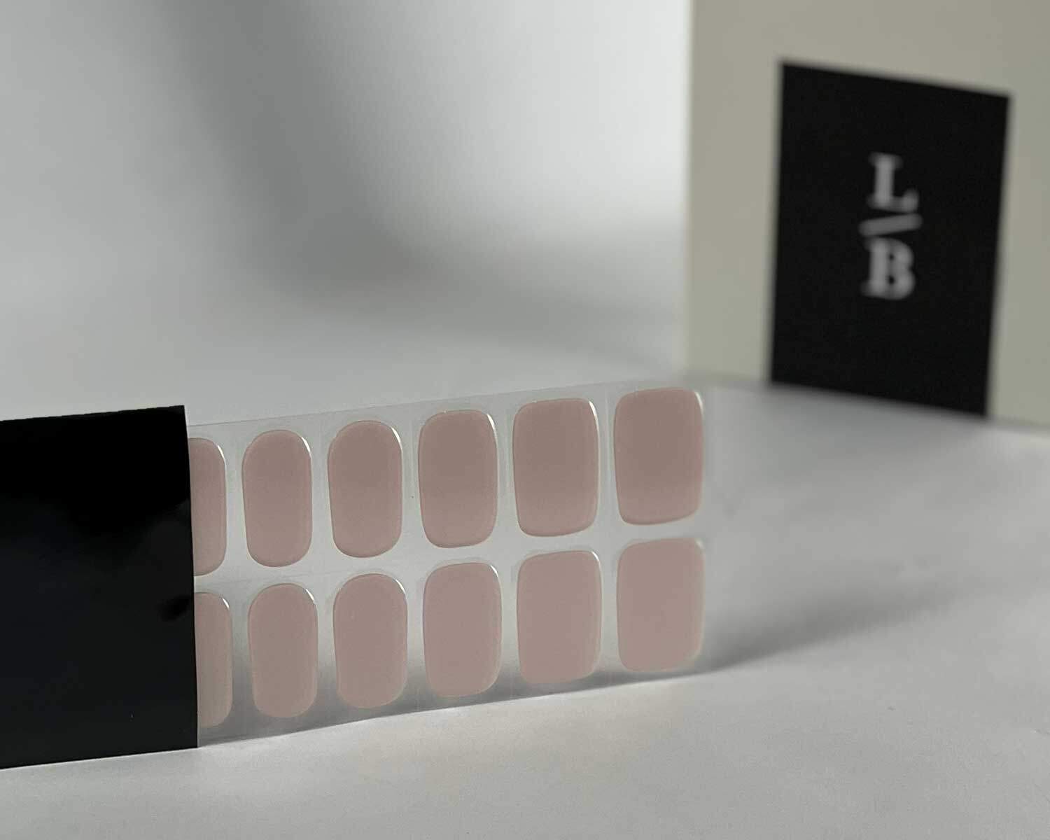 Pink Rose Garden semi-cured gel nails in black light sensitive strip with la-bek uv lamp box in the background