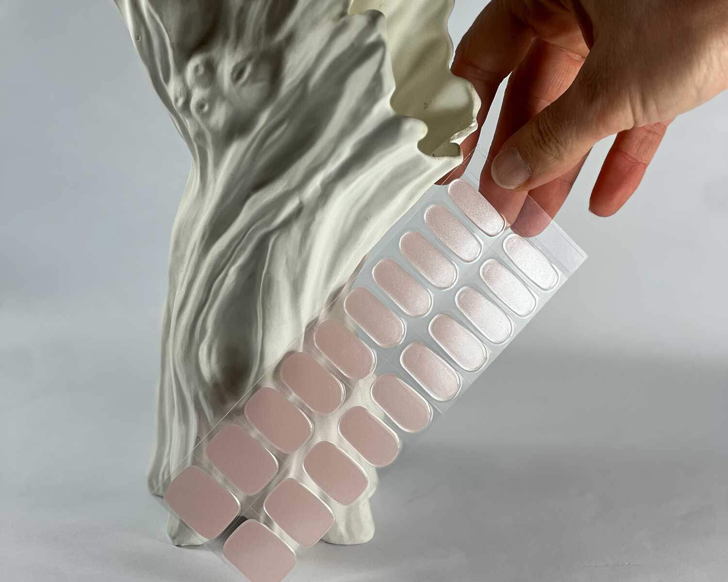 Pink Rose Garden semi-cured gel nails in mockup to show product against white textured tree with hand holding nail set