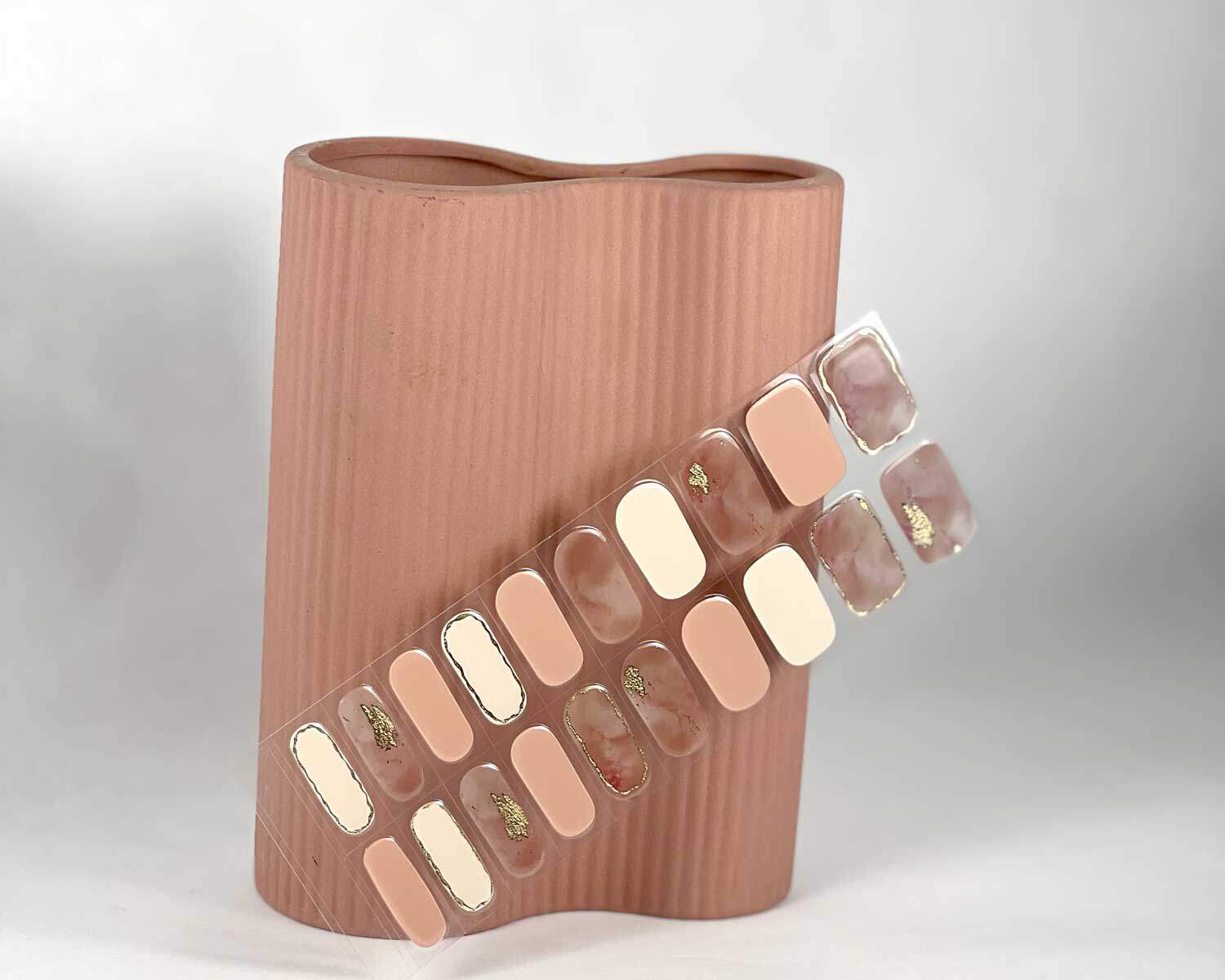 Gold Digger semi-cured gel nails in mockup to show product against pink vase