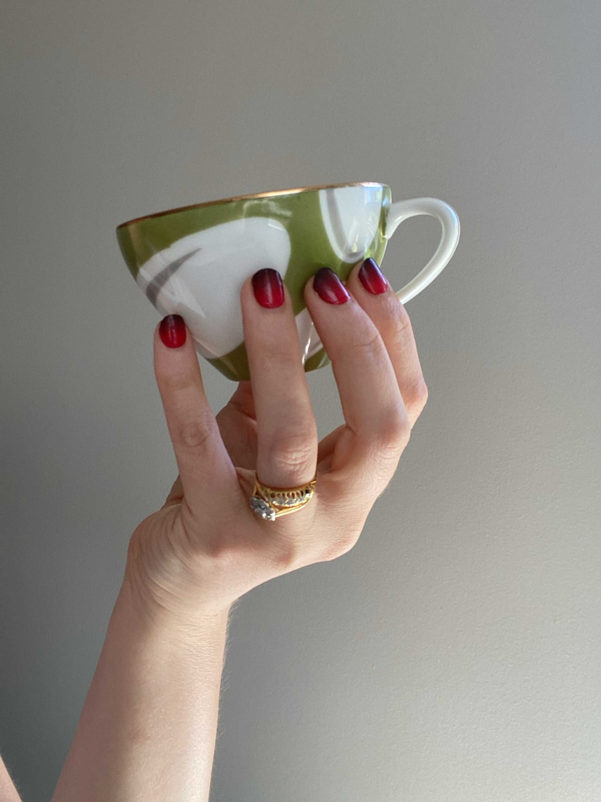 la-bek-nails-red-black-gradient-true-blood-uv-nails true blood semi-cured gel nails on nails holding a green and white tea cup