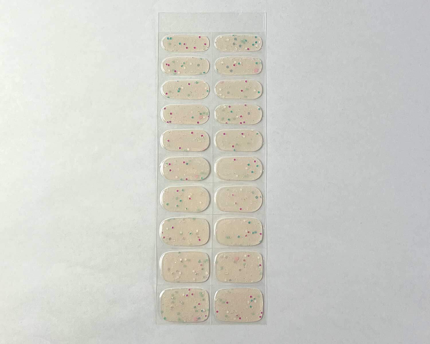 Sprinkle Glow in the dark white semi-cured gel nails strip showing 20 pieces with 10 different sizes on white background