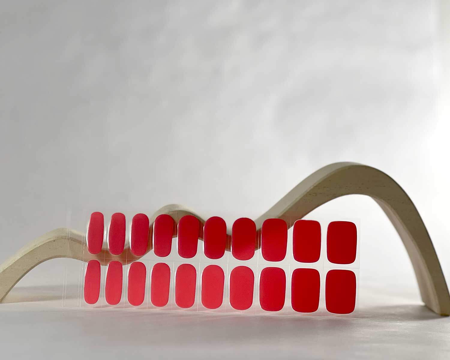 Watermelon Pink semi-cured gel nails in mockup to show product against white wave wooden block