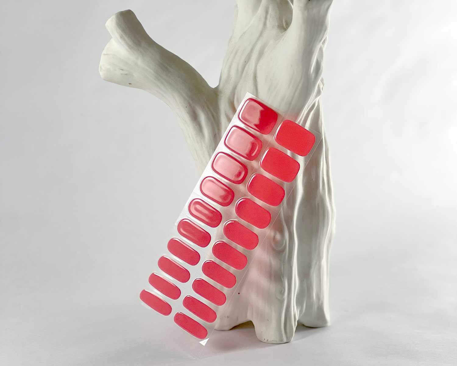 Watermelon Pink semi-cured gel nails in mockup to show product against white textured tree