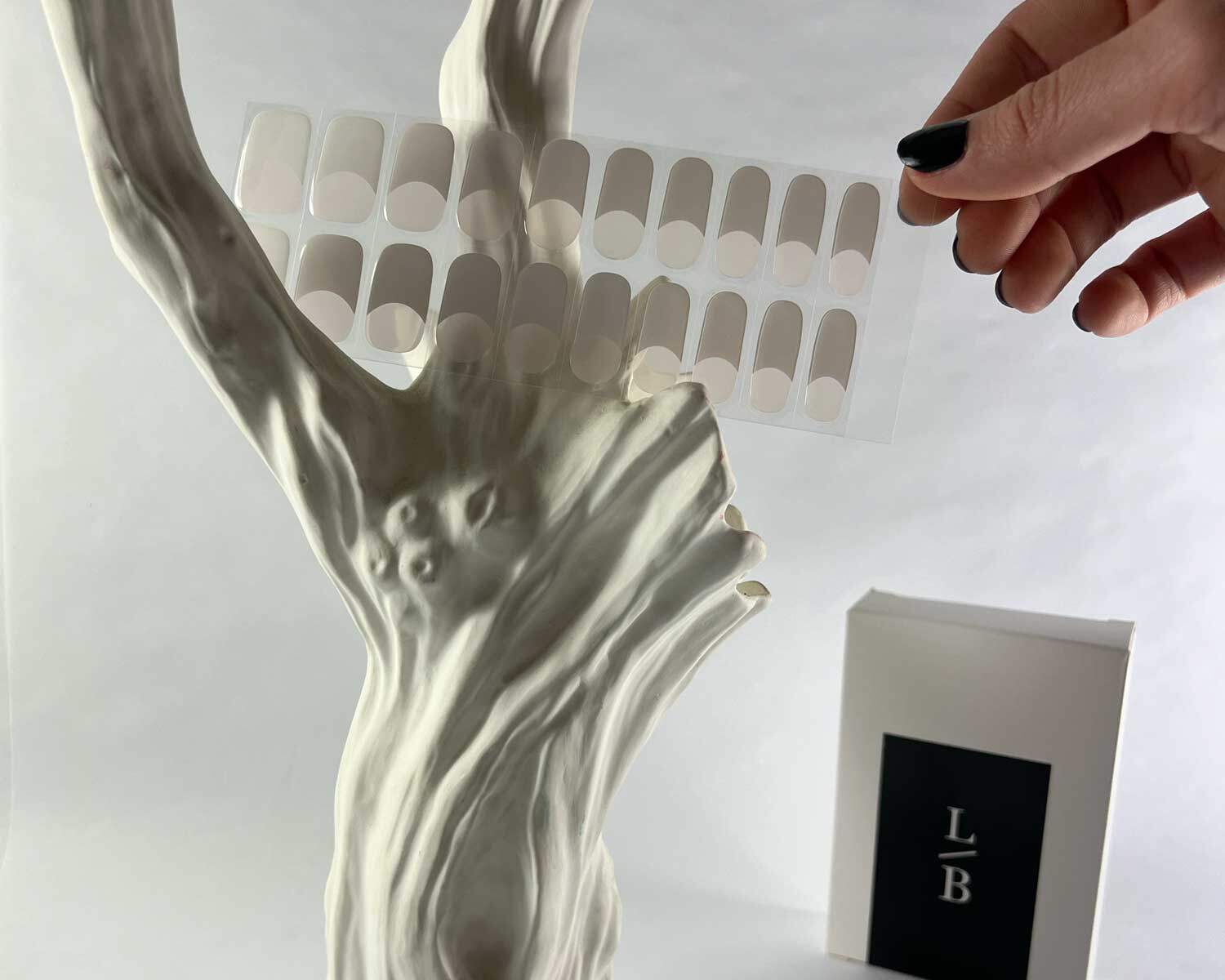 classic french semi cured gel nails in mockup to show product against white textured ceramic tree with la-bek uv lamp in the background